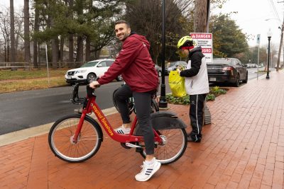 Silas Sullivan (at left) waits for his professor, Ralph Buehler (at right), to start a bike tour of Falls Church.