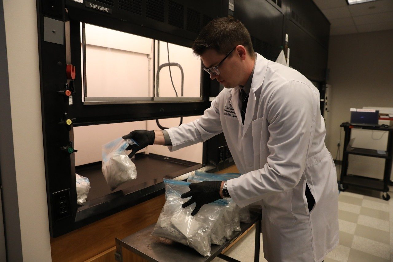Laboratories and Scientific Services (LSS) Scientist Removes Chemicals From Fume Chamber
